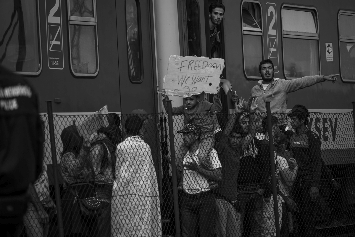 "Syrian refugees strike at the platform of Budapest Keleti railway station. Refugee crisis. Budapest, Hungary, Central Europe, 4 September 2015. (1)" by Mstyslav Chernov - Own work.